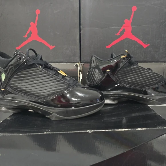 This is a pair of Air Jordan 2009 'S23' sneakers in the black and metallic gold